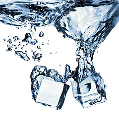 Image showing ice cubes dropped into water with splash isolated on white