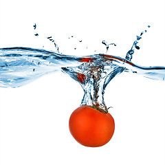 Image showing red tomato dropped into water isolated on white