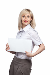 Image showing Attractive smiling woman holding white empty paper isolated on w