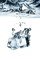 Image showing ice cubes dropped into water with splash isolated on white