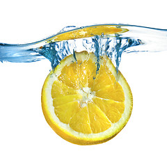 Image showing Fresh lemon dropped into water with splash isolated on white