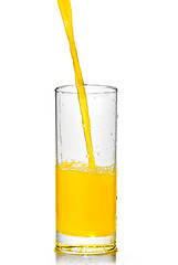 Image showing orange juice poring into glass isolated on white