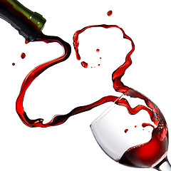 Image showing Heart from pouring red wine in goblet isolated on white