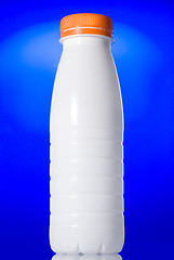 Image showing White milk bottle isolated on blue