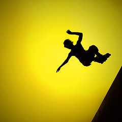 Image showing silhouette of roller boy jumping in air