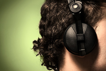 Image showing urban style photo of the man in headphones listening to musiñ