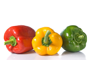 Image showing red, yellow and green pepper with water drops isolated on white