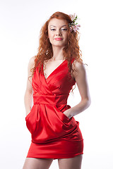 Image showing Portrait of woman in red dress with spring flowers on white