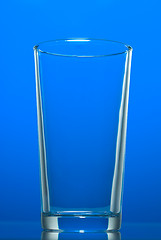 Image showing Empty glass isolated on blue