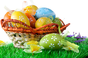 Image showing color easter eggs in basket isolated on white