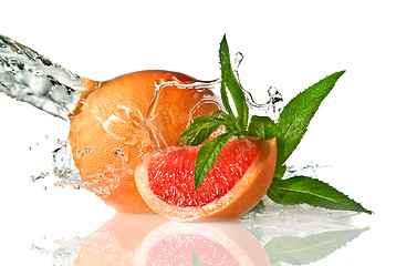 Image showing Water splash on grapefruit with mint isolated on white