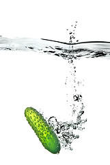 Image showing green cucumber dropped into water isolated on white