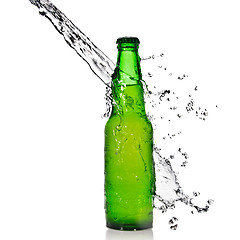 Image showing Green beer bottle with water splash isolated on white