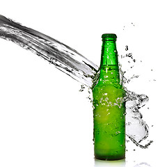 Image showing Green beer bottle with water splash isolated on white