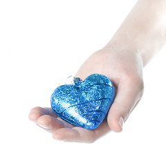 Image showing arm holding blue christmas ball in shape of heart isolated on wh