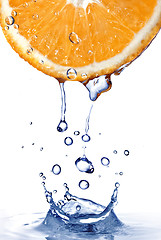 Image showing fresh water drops on orange with water splash isolated on white