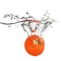 Image showing red tomato dropped into water isolated on white