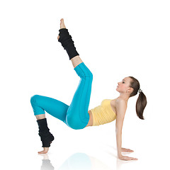 Image showing attractive woman doing gymnastics on white background