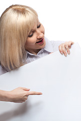 Image showing Attractive smiling woman holding white empty paper isolated on white