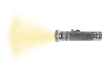 Image showing turned on metal flashlight isolated on white