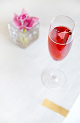 Image showing red alcohol cocktail in glass with orchid