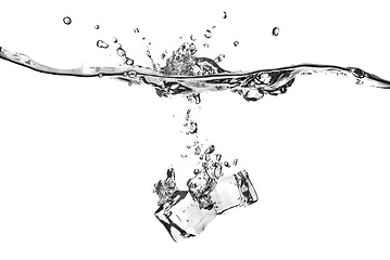 Image showing ice cubes dropped into water with splash isolated on white