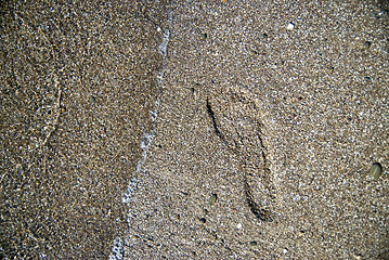 Image showing sand stones with footprint and water wave