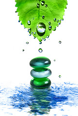 Image showing balancing spa shiny stones in water with leaf and drops isolated