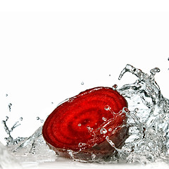 Image showing red beet with water splash isolated on white