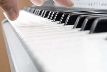 Image showing hand playing music on the piano