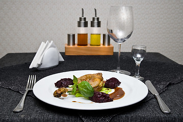 Image showing fried chicken on plate and served table