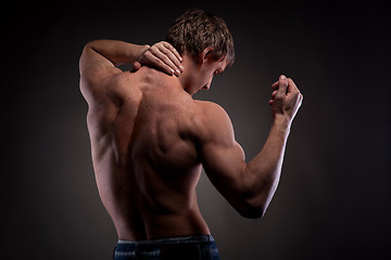 Image showing Muscular naked man from back on black