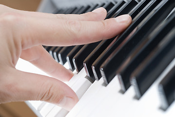 Image showing hand playing music on the piano