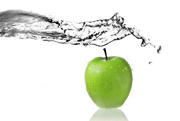 Image showing fresh water splash on green apple isolated on white