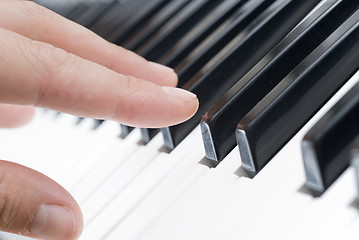 Image showing hand playing music on the piano