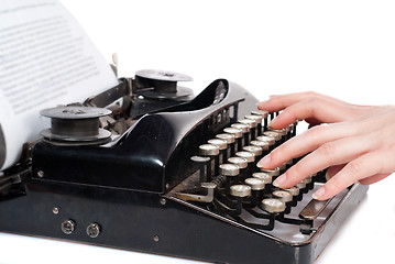 Image showing Woman hands typing on vintage typewriter isolated on white
