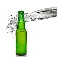 Image showing Green beer bottle with water splash isolated on white