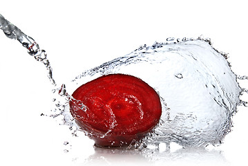 Image showing red beet with water splash isolated on white