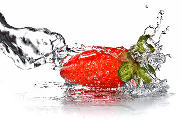 Image showing Fresh strawberry and water splash isolated on white