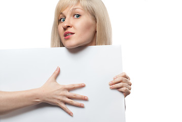 Image showing Attractive woman holding white empty paper isolated on white