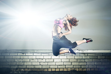 Image showing girl jumping on the roof