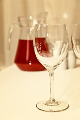 Image showing glass goblet and red beverage on the table