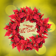 Image showing christmas wreath from poinsettia on yellow light background