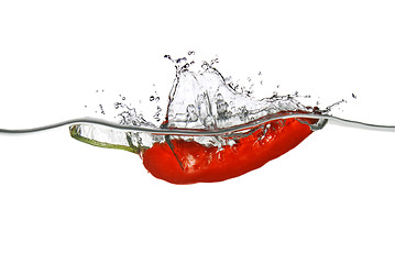 Image showing red pepper dropped into water with splash isolated on white