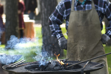 Image showing Smith against fireplace with instruments