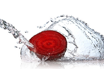 Image showing red beet with water splash isolated on white