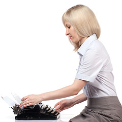 Image showing Business woman with vintage typing machine on white