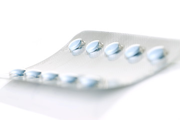 Image showing pack of blue tablets isolated on white
