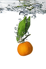 Image showing Splash of orange to water with bubbles of air