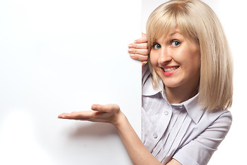 Image showing Attractive smiling woman holding white empty paper isolated on w